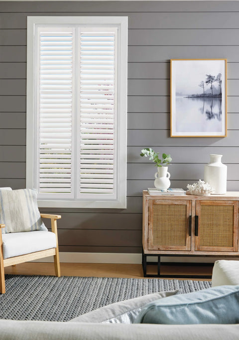 Living room with a white Prefect fit shutters on a grey panelled wall